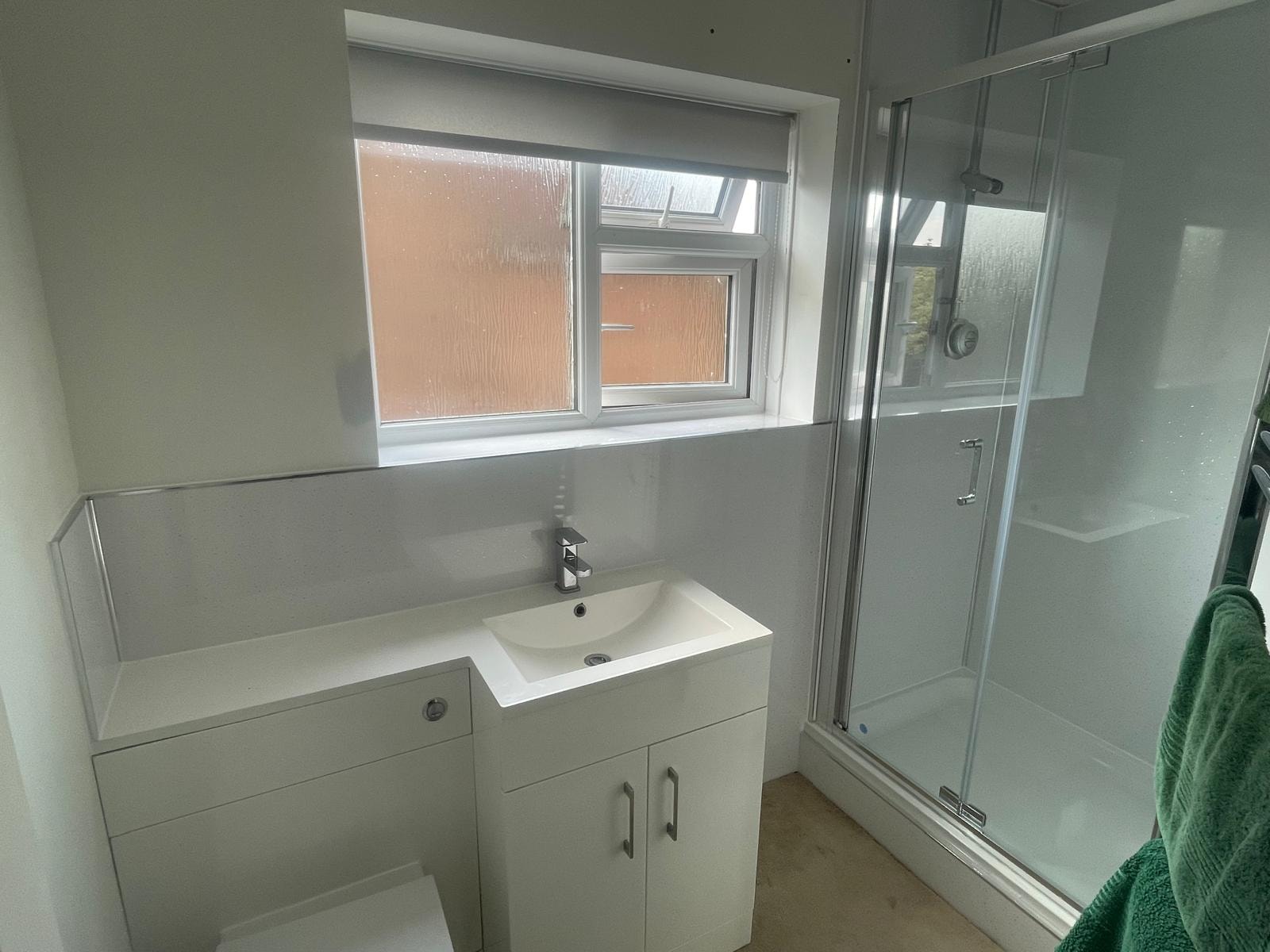 Bathroom reseal — vanity unit, sink and shower enclosure with chrome fittings