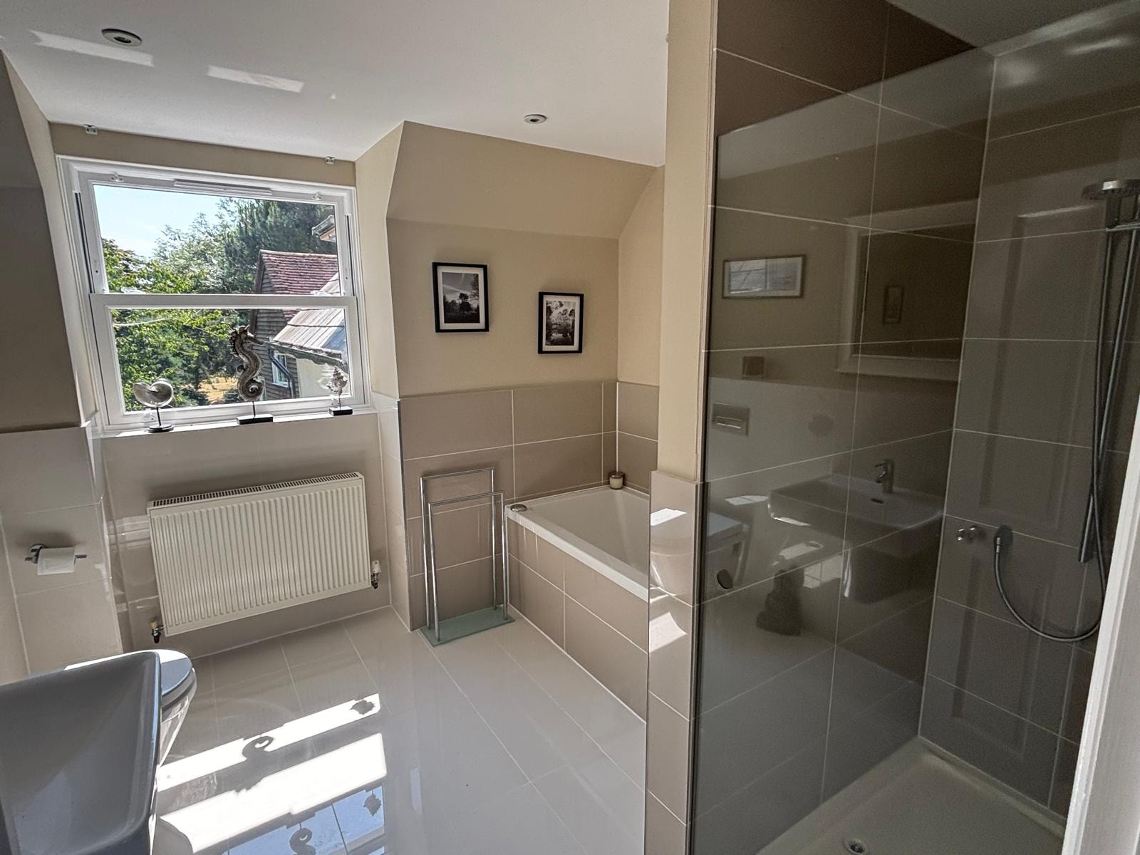 Bathroom reseal — tiled wet room with walk-in shower and white floor tiles