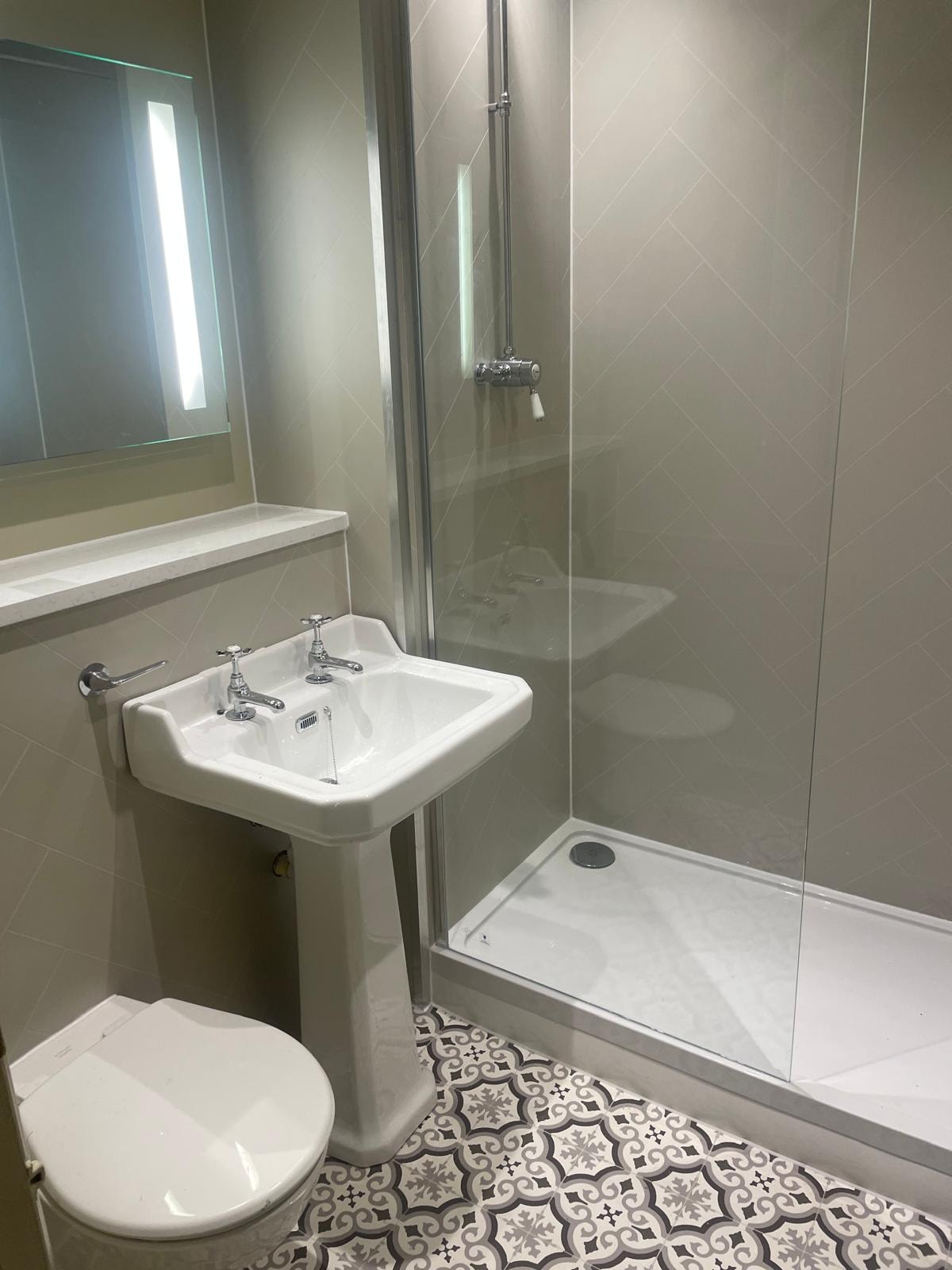 Dog & Bear Hotel — refurbished en-suite with herringbone tiles, pedestal basin and walk-in shower