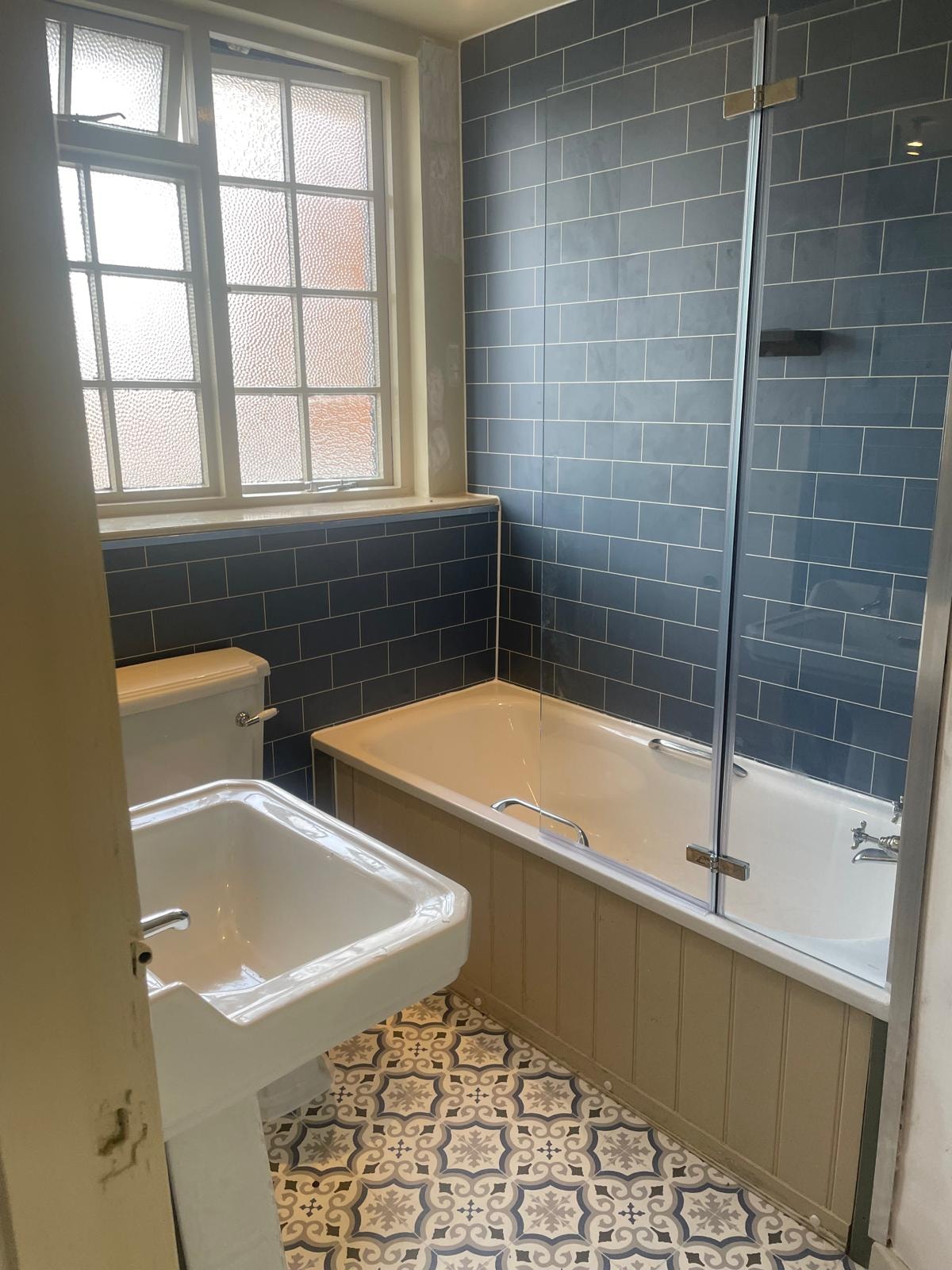 Dog & Bear Hotel — refurbished en-suite with blue metro tiles, bath and shower screen