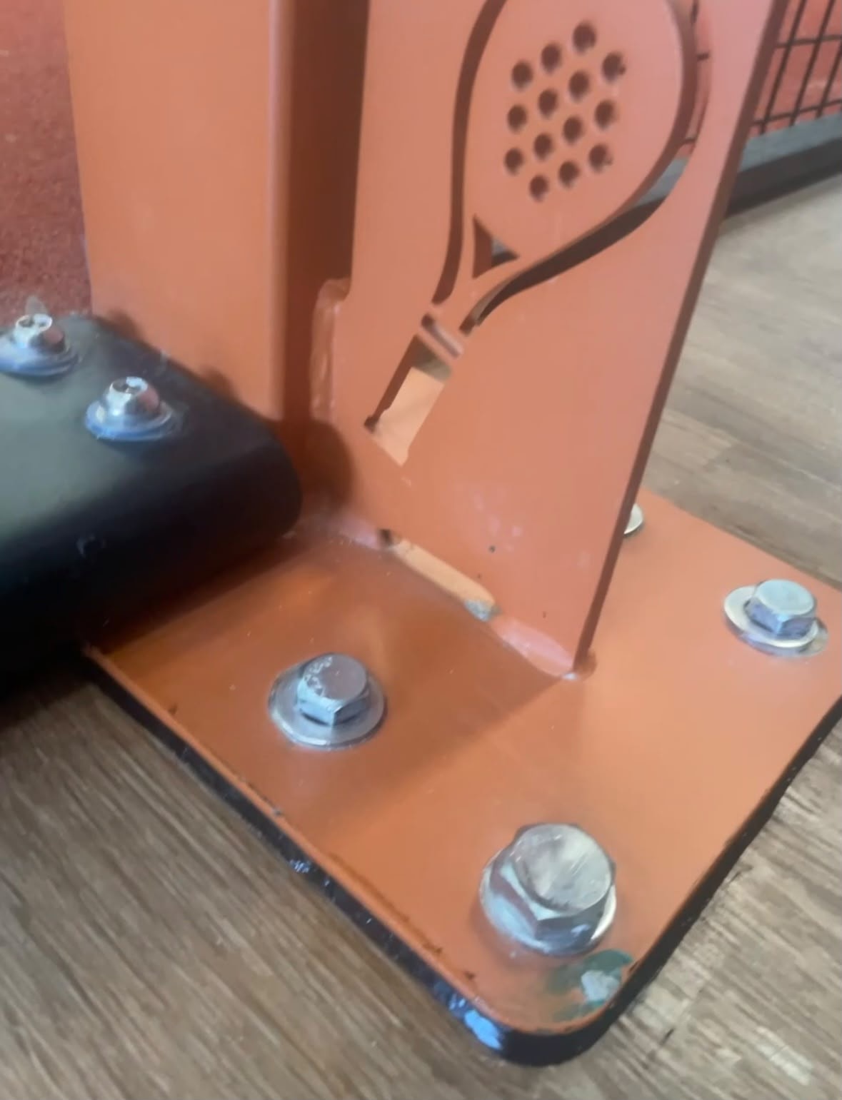 Forever Padel — orange padel court bracket sealing detail