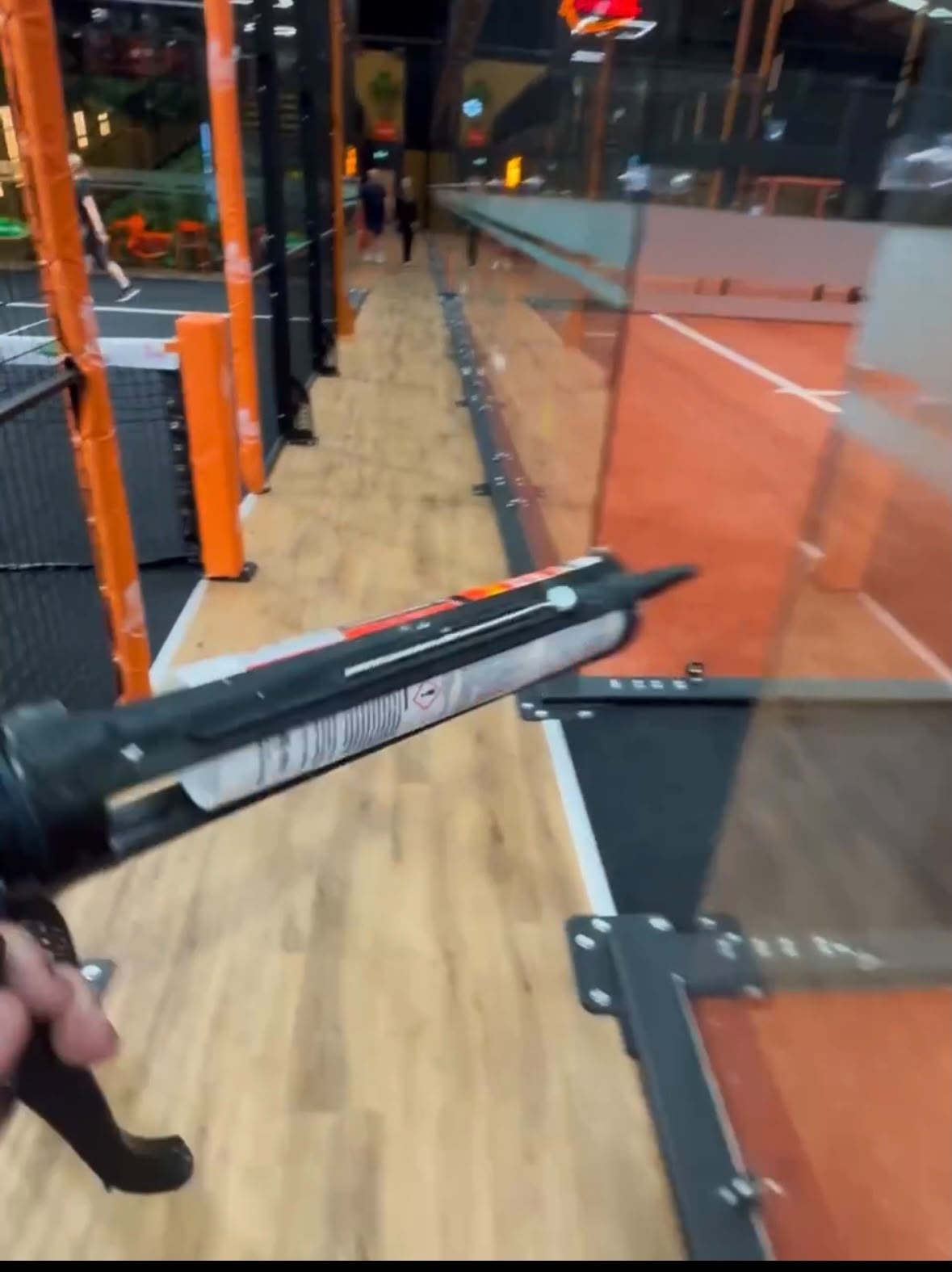 Forever Padel — mastic gun sealing court floor perimeter