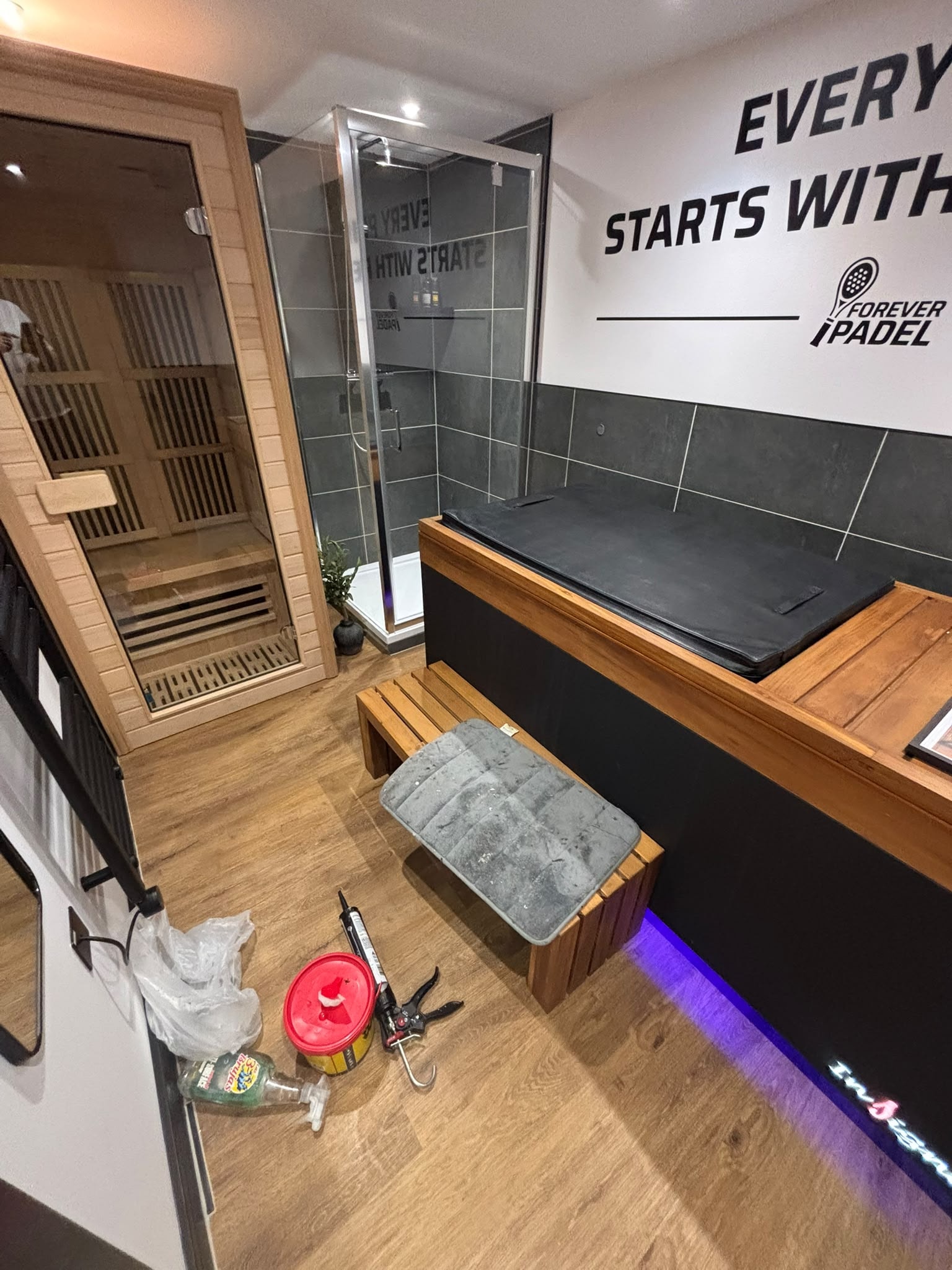 Forever Padel — sauna, shower enclosure and ice bath wellness area during fit-out