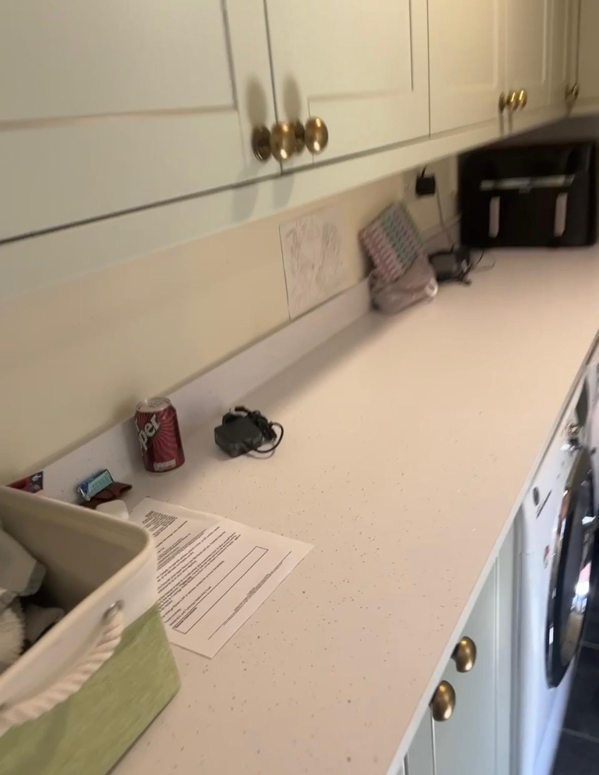 Cream kitchen with quartz worktop and glass splashback — mastic sealed